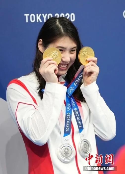 东京奥运会，张雨霏展示自己的四块奖牌，拍照留念。<a target=